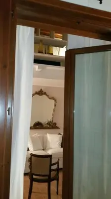 a room with a table and a chair and a mirror at Penthouse Luxury Quattro Canti in Palermo