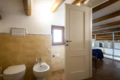 a bathroom with a toilet and a sink at Penthouse Luxury Quattro Canti in Palermo