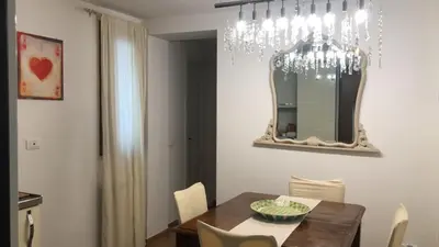 a dining room with a table and a mirror at Penthouse Luxury Quattro Canti in Palermo
