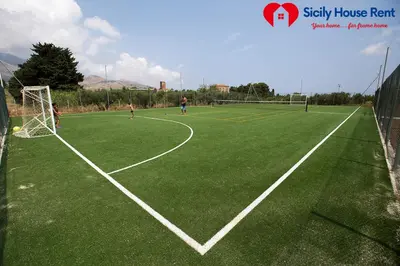 two people playing soccer on a soccer field at Borgo Aranci - Appartamento in Villa Garofalo - 15B in Castellammare del Golfo
