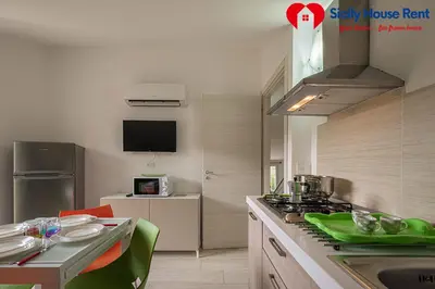 a kitchen with a sink and a stove top oven at Borgo Aranci - Appartamento in Villa Garofalo - 15B in Castellammare del Golfo