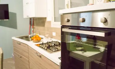 a kitchen with an oven and a sink in it at Le Case di Ninni in Palermo