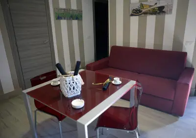 a living room with a red couch and a table at Le Case di Ninni in Palermo