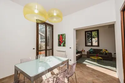 a dining room with a table and chairs at LuminHouse Mondello Fico in Mondello