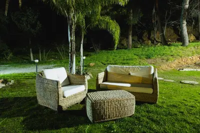 two chairs and a couch sitting in the grass at LuminHouse Mondello Fico in Mondello