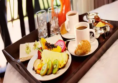 a tray with two plates of food and cups of coffee at LuminHouse Mondello Fico in Mondello