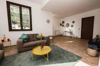 a living room with a couch and a table at LuminHouse Mondello Fico in Mondello