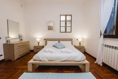 a bedroom with a bed and two night stands at LuminHouse Mondello Zibibbo in Mondello