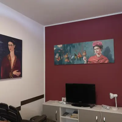 a living room with two paintings on the wall at Casa Frida in San Vito lo Capo