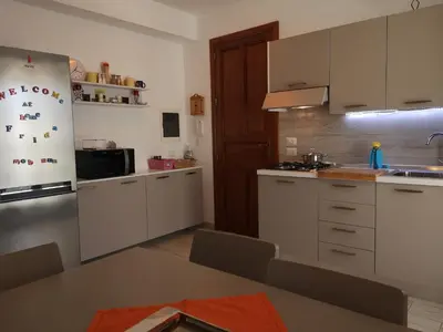 a kitchen with white cabinets and a refrigerator at Casa Frida in San Vito lo Capo