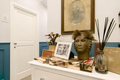 a table with a bust of a head on it at Family Affair Luxury Rooms&Suites in Palermo