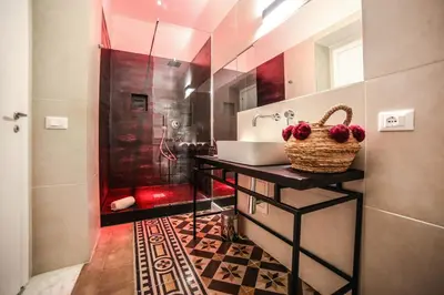 a bathroom with a sink and a shower at Family Affair Luxury Rooms&Suites in Palermo