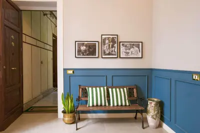 a hallway with a bench and a blue wall at Family Affair Luxury Rooms&Suites in Palermo
