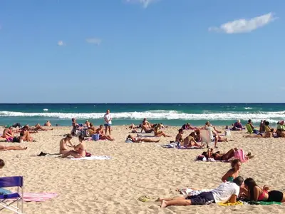 a group of people laying on the beach at Near the beach in Palermo