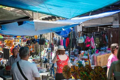 a group of people walking around an outdoor market at APT Ballarò House - Superior Apartment in Palermo