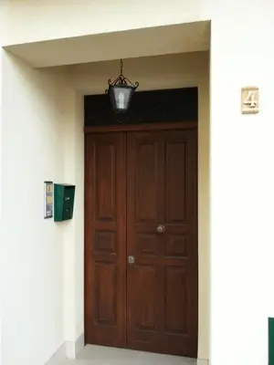 a wooden door in a building with a light above it at Casa dolce Casa in Sambuca di Sicilia