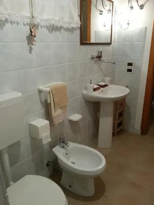 a bathroom with a white toilet and a sink at Casa dolce Casa in Sambuca di Sicilia