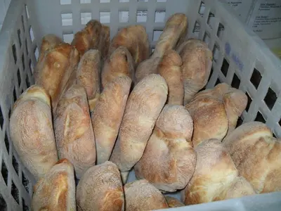 a basket filled with lots of loaves of bread at Agriturismo La Targa in Buonfornello