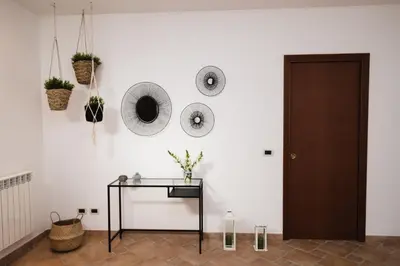 a room with a table and mirrors on the wall at LuminHouse Villa Mondello in Mondello