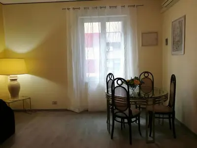 a dining room with a table and a window at Pretty house in Palermo