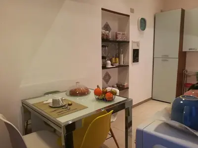 a table with a bowl of fruit on it in a kitchen at Pretty house in Palermo