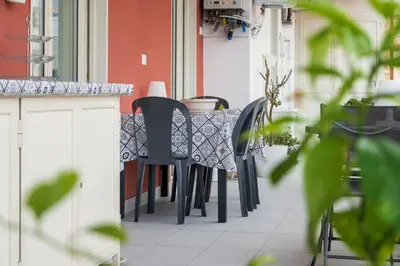 a row of black chairs sitting at a table at Ciccio Rooms and breakfast - Self check-in in Palermo