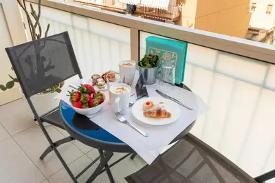 a table with a plate of food and a bowl of fruit at Ciccio Rooms and breakfast - Self check-in in Palermo