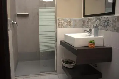 a bathroom with a sink and a shower at SuiteSicily Rooms Palermo in Altavilla Milicia