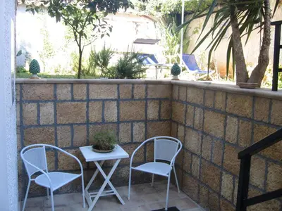 two chairs and a table on a patio at Appartamento Vivaldi in Mondello