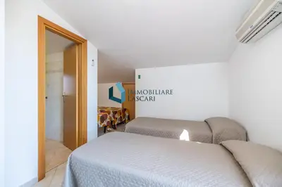 a bedroom with two beds in a room at Villa Siragusa con piscina condominiale in Campofelice di Roccella
