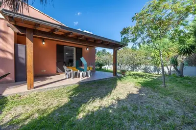 a porch of a house with chairs on it at Villa Siragusa con piscina condominiale in Campofelice di Roccella