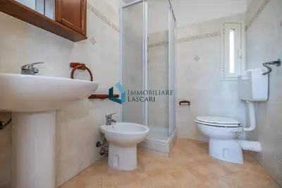 a bathroom with a sink and a toilet and a shower at Villa Siragusa con piscina condominiale in Campofelice di Roccella
