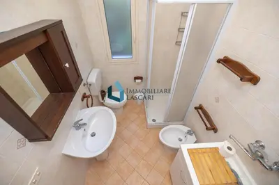 a bathroom with a sink and a toilet and a sink at Villa Siragusa con piscina condominiale in Campofelice di Roccella