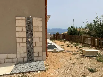 a shower in the side of a house at La Finestra sul Mare dello Zingaro in Scopello