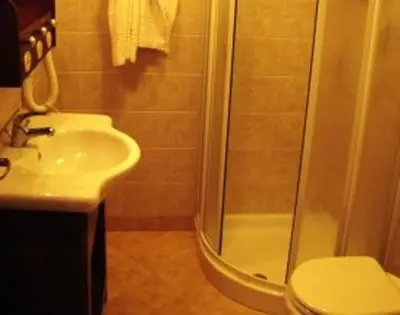 a bathroom with a shower and a sink and a toilet at Torre Salina in Macari