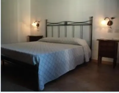 a bedroom with a bed and two night stands at Torre Salina in Macari