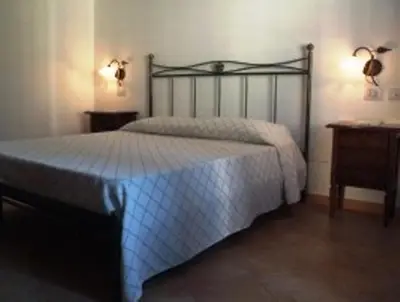 a bedroom with a bed and two night stands at Torre Salina in Macari