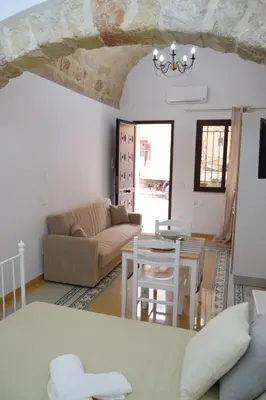 a living room with a couch and a table at Le Volte - Locazione Turistica in Terrasini