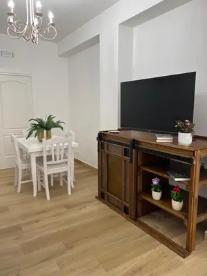 a living room with a television on a wooden entertainment center at Caporama in Terrasini