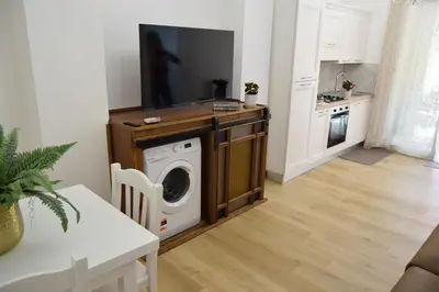 a living room with a washing machine and a tv at Caporama in Terrasini