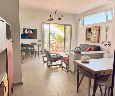 a living room with a couch and a table at Casa in villa vista mare in Palermo
