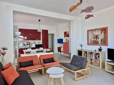 a living room with a couch and chairs and a table at Casa in villa vista mare in Palermo