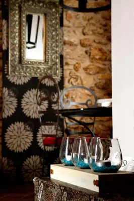 a row of wine glasses sitting on a table at Il Baglio Della Luna Relais by Le Dhome Sicily in Balestrate