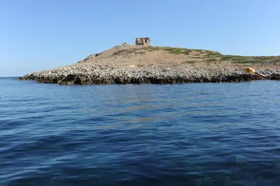an island in the water with a castle on it at Casa Genna in Isola delle Femmine