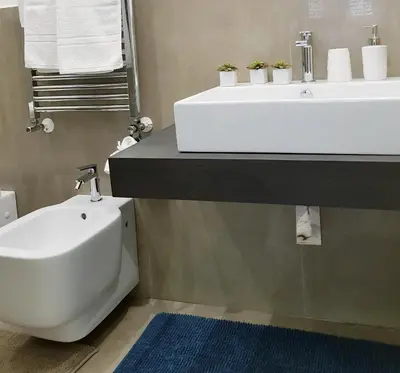 a bathroom with a white sink and a toilet at Le Casette di Marcì in Palermo