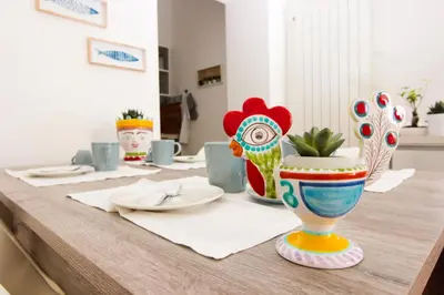 a table with several colorful vases on top of it at Le Casette di Marcì in Palermo