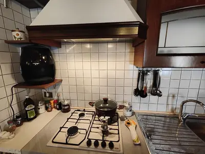 a kitchen with a stove with a pot on it at Casa Vacanza Isola sul Mare in Castellammare del Golfo