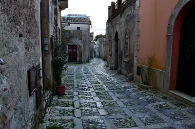 an alley in an old town with a cobblestone street at Casa Vacanza Isola sul Mare in Castellammare del Golfo