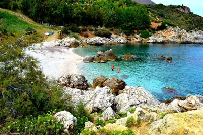 a group of people swimming in a body of water at Casa Vacanza Isola sul Mare in Castellammare del Golfo