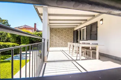 a balcony of a house with a table and chairs at Villa Sara in Lascari